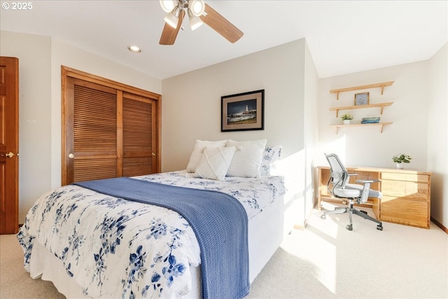 carpeted bedroom featuring ceiling fan and a closet