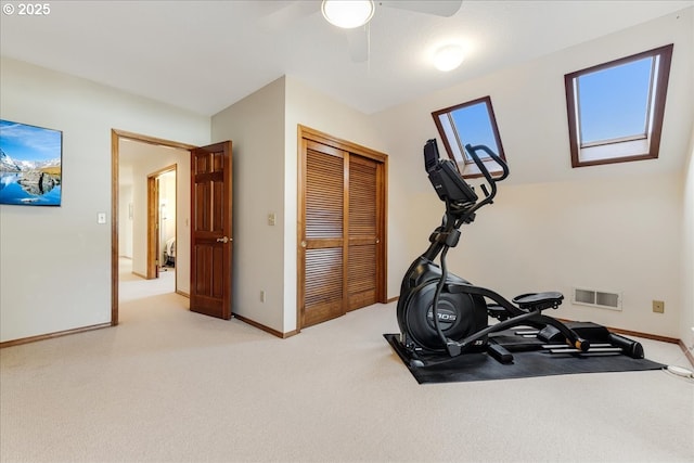 workout area with ceiling fan and carpet