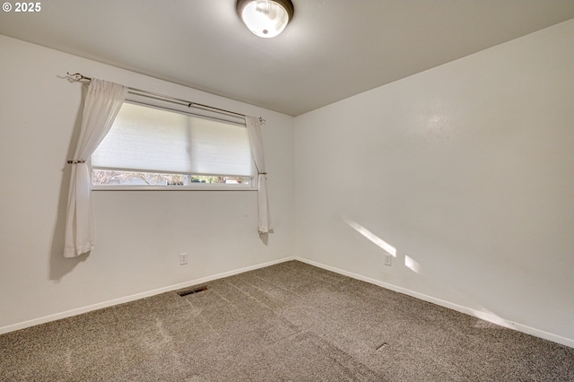 empty room with baseboards, carpet flooring, and visible vents