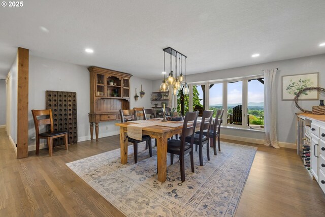 dining space featuring recessed lighting, baseboards, and wood finished floors