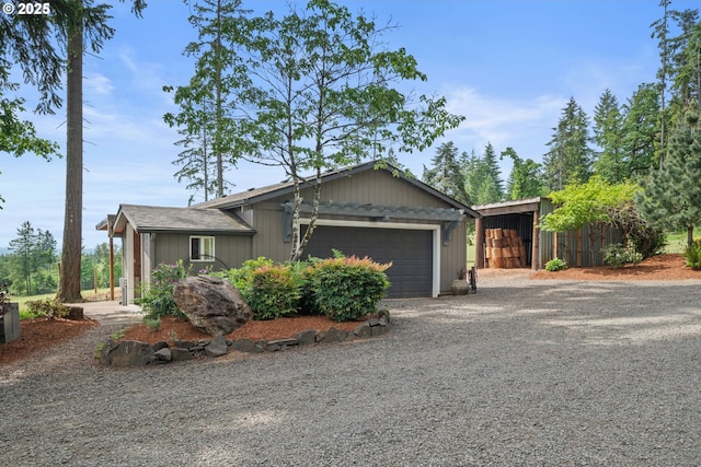 view of front facade with gravel driveway and a garage