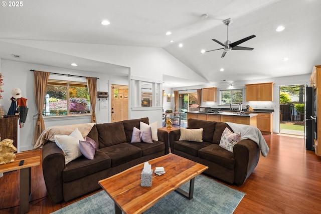 living area featuring dark wood-type flooring, lofted ceiling, ceiling fan, and recessed lighting