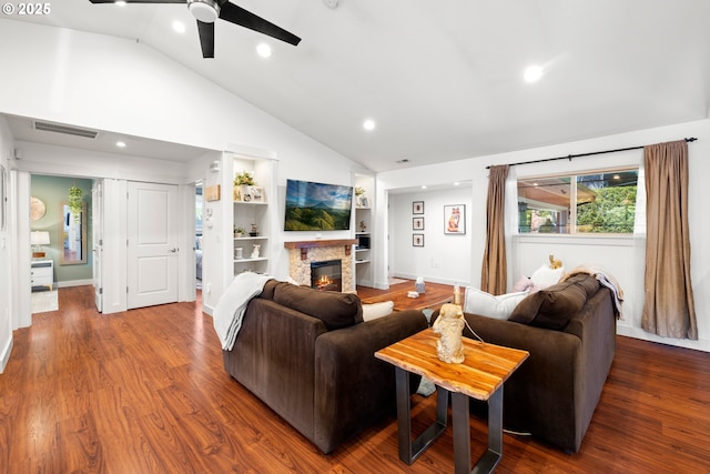 living room featuring a stone fireplace, ceiling fan, visible vents, high vaulted ceiling, and wood finished floors
