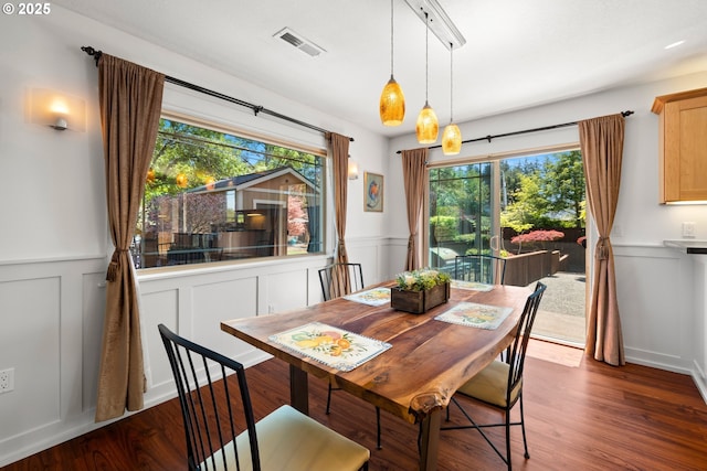 dining room featuring a wainscoted wall, visible vents, and a decorative wall