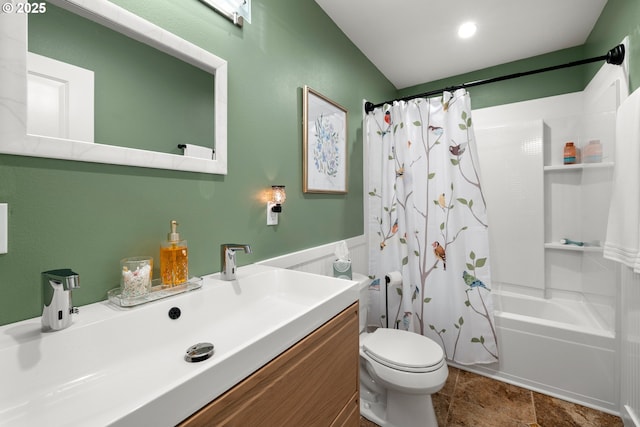 bathroom featuring a wainscoted wall, vanity, toilet, and shower / bathtub combination with curtain
