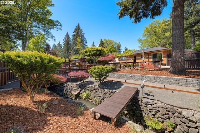 view of yard featuring a fenced backyard and a playground