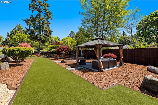 view of yard featuring a fenced backyard, a gazebo, and a patio