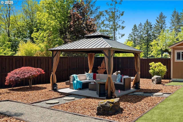 view of patio with a fenced backyard, a gazebo, and an outdoor living space