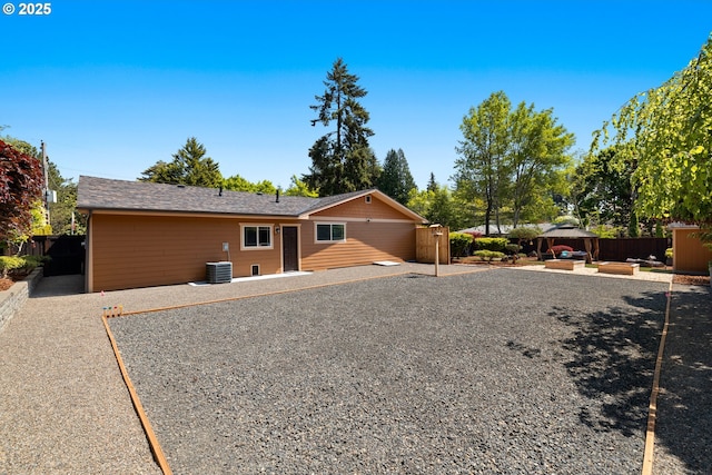 back of house featuring central AC unit, fence, a gazebo, and a patio