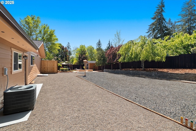 view of yard with cooling unit and a fenced backyard