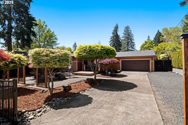3985 SW 102nd Ave, Beaverton, OR 97005 - obstructed view of property featuring driveway, an attached garage, and a gate