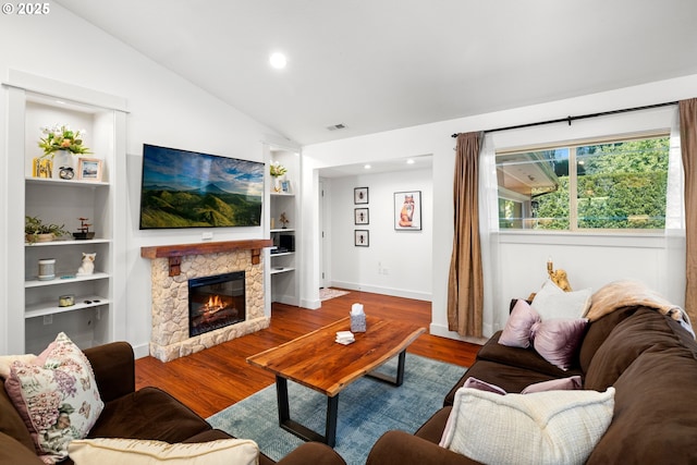 living room featuring wood finished floors, visible vents, built in features, lofted ceiling, and recessed lighting