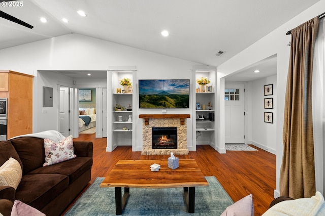 living room featuring vaulted ceiling, recessed lighting, visible vents, and wood finished floors