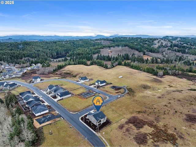 aerial view featuring a forest view and a residential view