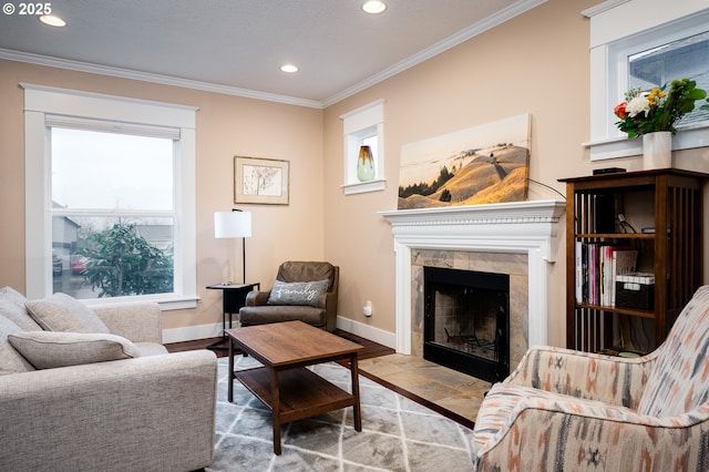 sitting room with a tiled fireplace, crown molding, and wood-type flooring