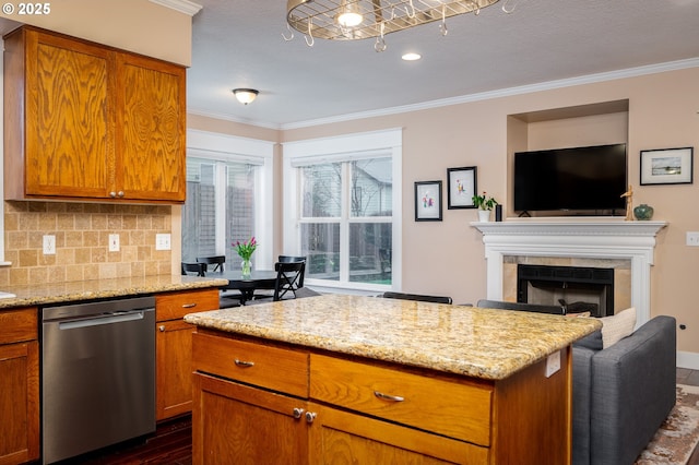 kitchen featuring dishwasher, ornamental molding, and light stone counters