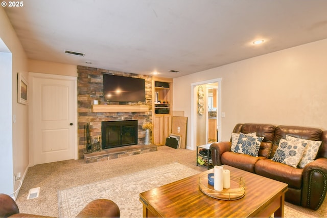 carpeted living room with visible vents and a fireplace