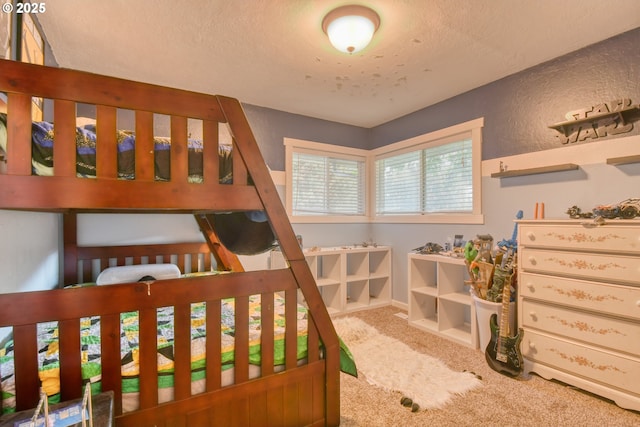 carpeted bedroom with a textured ceiling and a textured wall