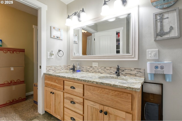 bathroom with double vanity, backsplash, and a sink