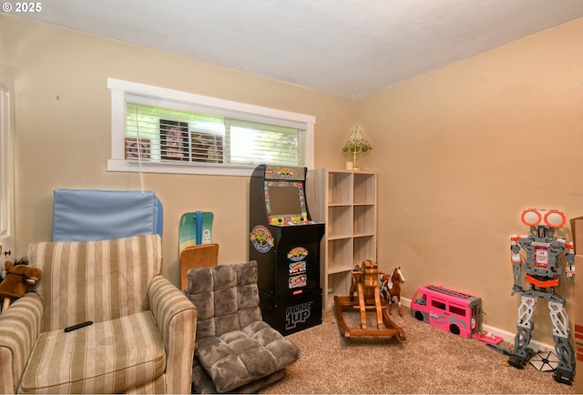 sitting room with baseboards and carpet floors