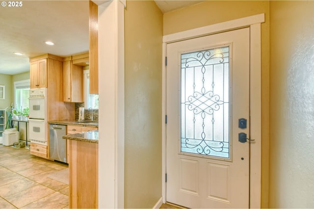 entryway with recessed lighting and light tile patterned floors