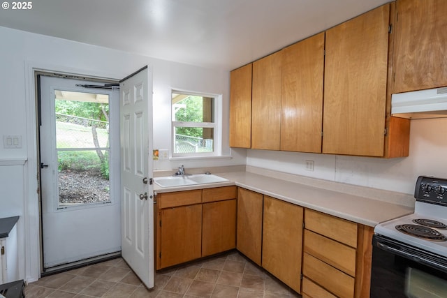731 NE Casper St, Roseburg, OR 97470 - kitchen featuring electric stove, a sink, under cabinet range hood, and light countertops