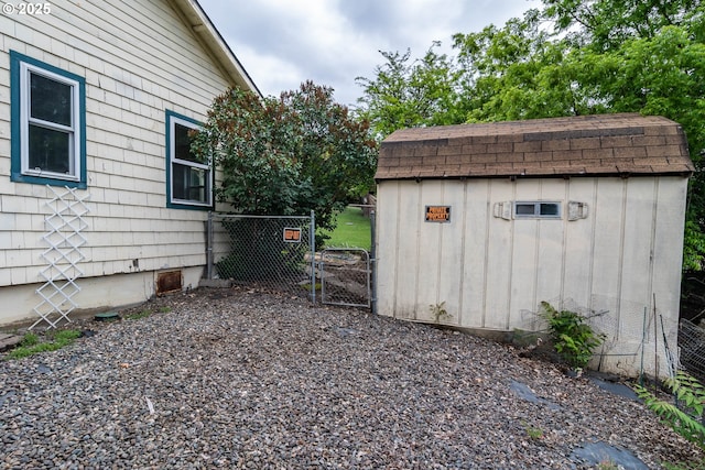 731 NE Casper St, Roseburg, OR 97470 - view of yard with fence, a storage unit, an outbuilding, and a gate