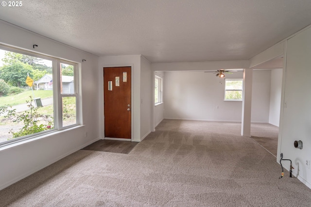 731 NE Casper St, Roseburg, OR 97470 - foyer entrance featuring carpet, healthy amount of natural light, a ceiling fan, baseboards, and a textured ceiling