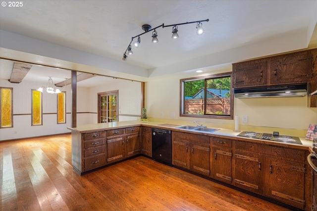 65257 E Sandy River Ln, Rhododendron, OR 97049 - kitchen featuring under cabinet range hood, black dishwasher, electric cooktop, a sink, and wood finished floors