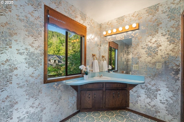 65257 E Sandy River Ln, Rhododendron, OR 97049 - bathroom featuring vanity, baseboards, and wallpapered walls