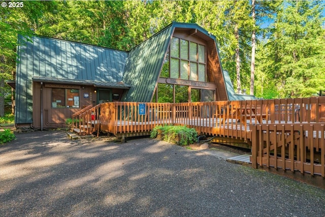 65257 E Sandy River Ln, Rhododendron, OR 97049 - view of front of property featuring a wooden deck, metal roof, and a standing seam roof
