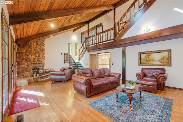 65257 E Sandy River Ln, Rhododendron, OR 97049 - living area featuring stairs, wood finished floors, wood ceiling with exposed beams, and high vaulted ceiling