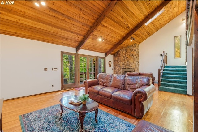 65257 E Sandy River Ln, Rhododendron, OR 97049 - living room featuring wood ceiling with exposed beams, stairway, wood finished floors, a fireplace, and baseboards