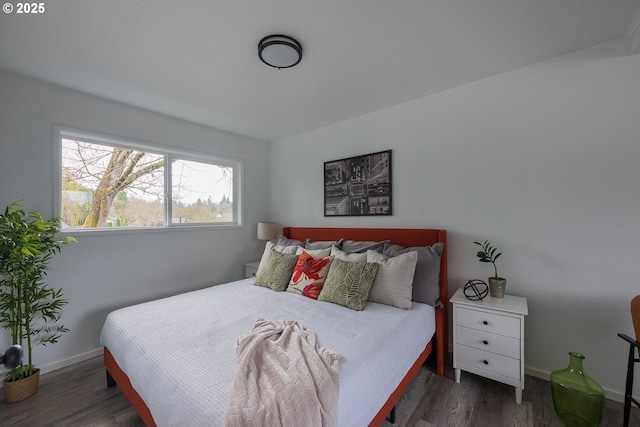 bedroom with baseboards and wood finished floors