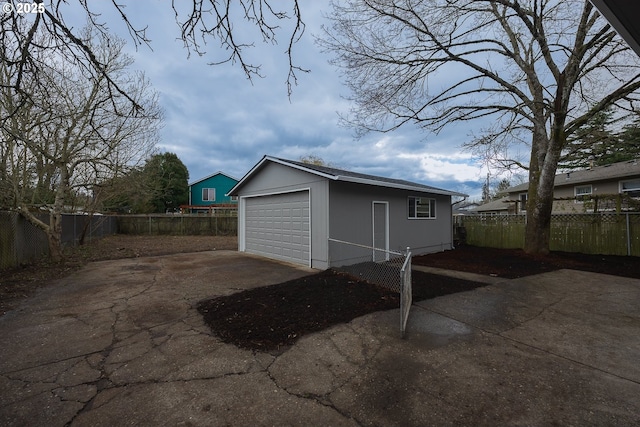 detached garage with driveway and fence