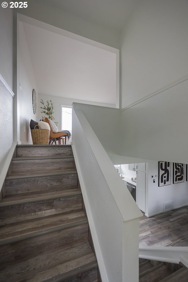 stairs featuring wood finished floors and visible vents