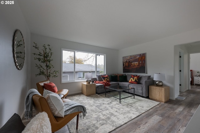 living room with baseboards and wood finished floors