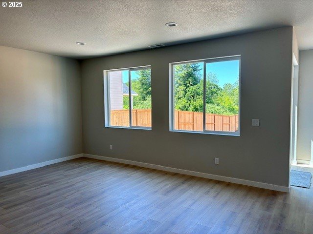 1747 N Millican Creek St, Lafayette, OR 97127 - empty room featuring wood finished floors, a textured ceiling, and baseboards