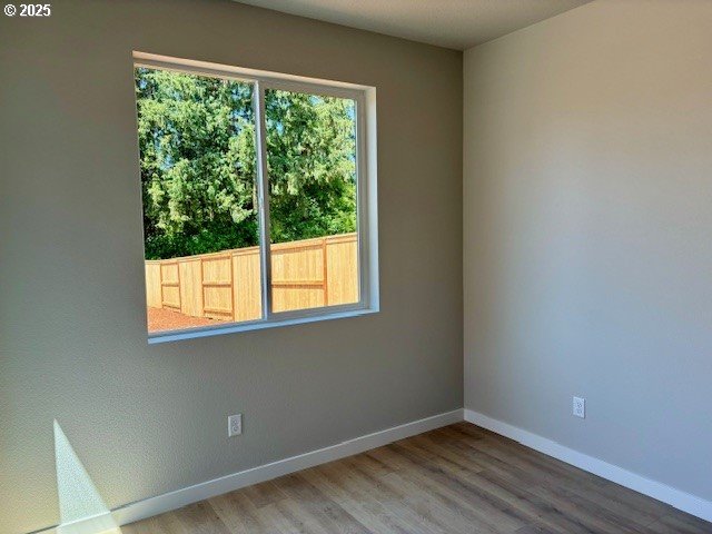 1747 N Millican Creek St, Lafayette, OR 97127 - spare room featuring wood finished floors and baseboards