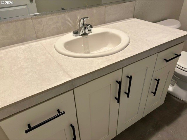 1747 N Millican Creek St, Lafayette, OR 97127 - bathroom featuring toilet, vanity, and tasteful backsplash