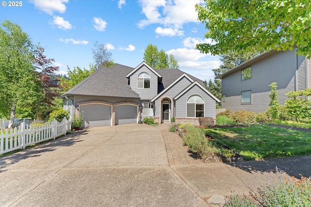 traditional-style house featuring a garage, driveway, brick siding, and a shingled roof