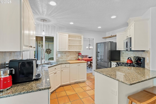 kitchen with appliances with stainless steel finishes, a sink, open shelves, tasteful backsplash, and recessed lighting