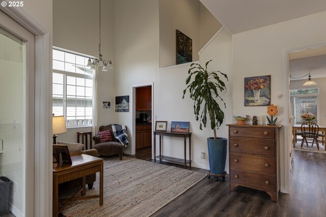 7125 SW Fallen Leaf St, Wilsonville, OR 97070 - living area with dark wood-style floors, a chandelier, and a towering ceiling