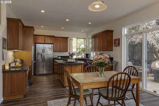 7125 SW Fallen Leaf St, Wilsonville, OR 97070 - kitchen featuring stainless steel fridge with ice dispenser, dark countertops, dark wood-style flooring, recessed lighting, and brown cabinets