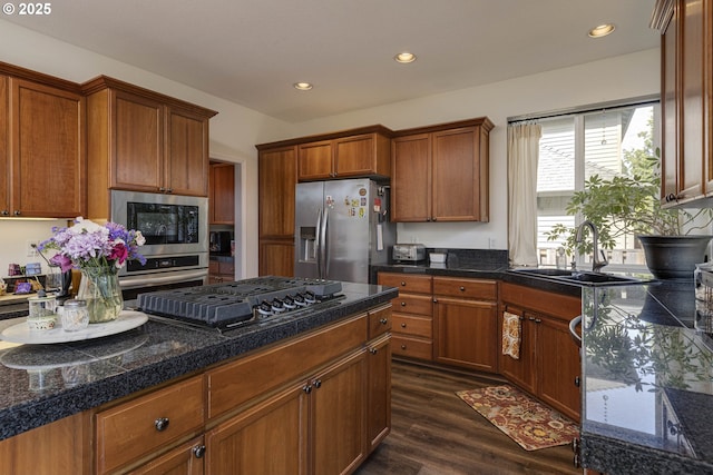 7125 SW Fallen Leaf St, Wilsonville, OR 97070 - kitchen with stainless steel appliances, tile counters, dark wood-type flooring, brown cabinets, and recessed lighting