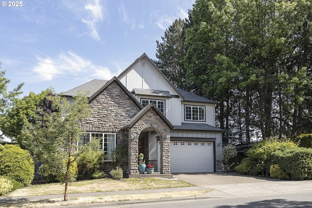 7125 SW Fallen Leaf St, Wilsonville, OR 97070 - english style home with stone siding, driveway, stucco siding, and a garage