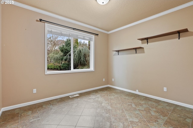 spare room with a textured ceiling, baseboards, visible vents, and crown molding