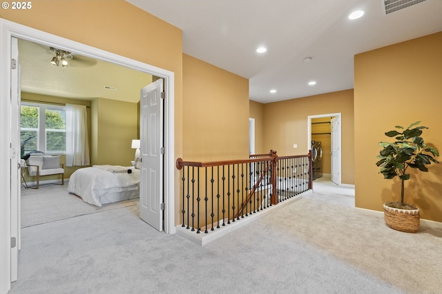 hallway with baseboards, visible vents, carpet flooring, and recessed lighting