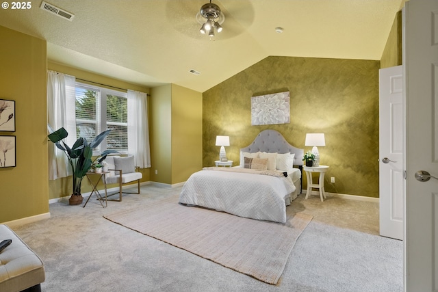 carpeted bedroom with lofted ceiling, an accent wall, visible vents, and baseboards