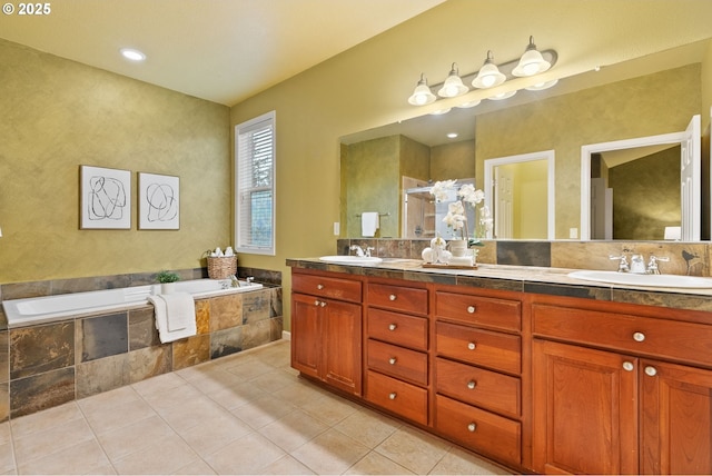 full bath with tile patterned flooring, a sink, a bath, and double vanity
